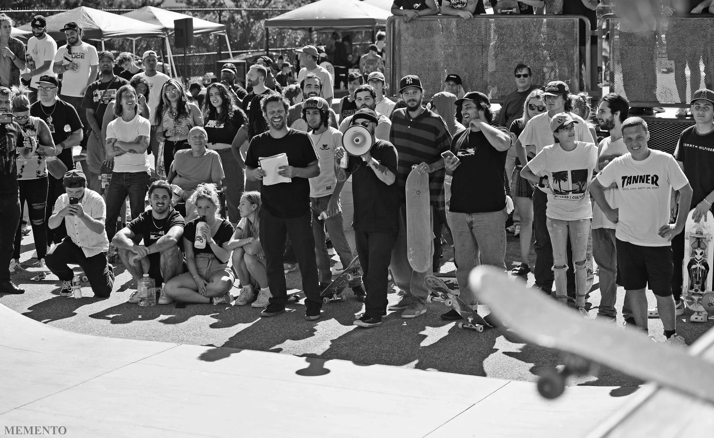A group of people at a skatepark watching a skate competition
